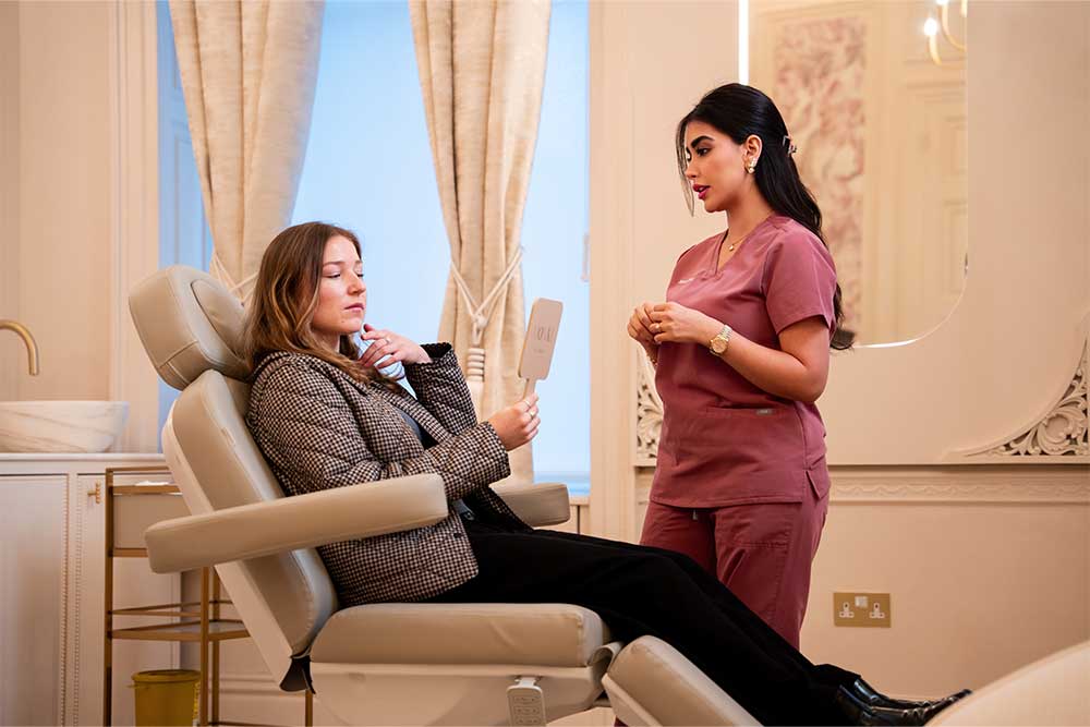 Mona Zirak, founder of Monaz Clinic, consulting a patient during a medical aesthetics treatment planning session.