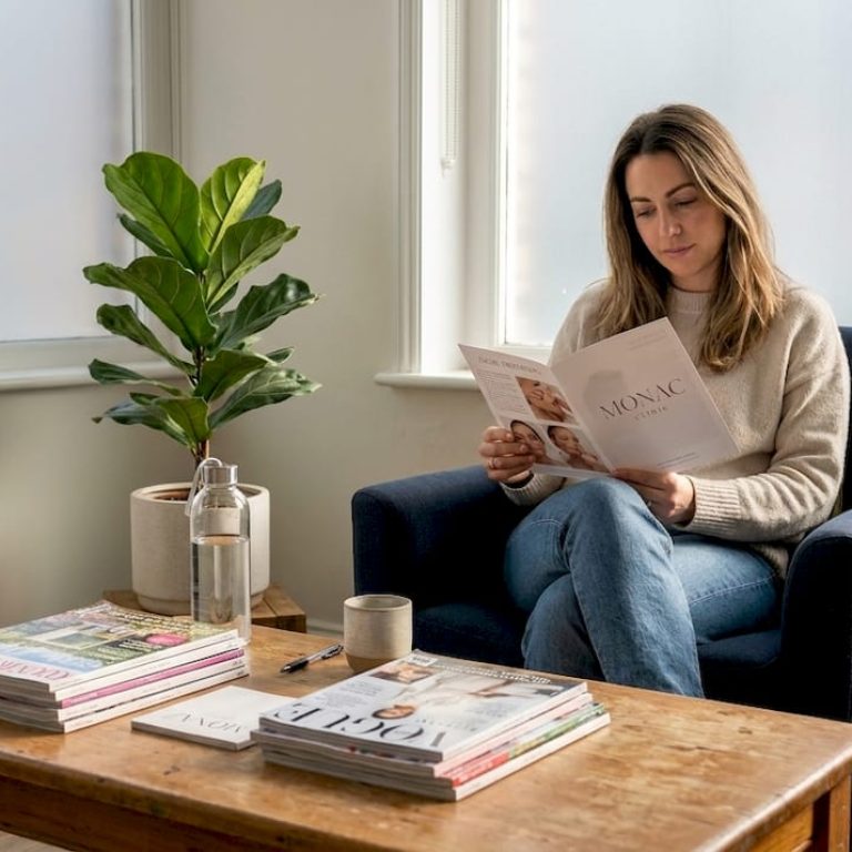 Woman reading brochure in London clinic waiting room