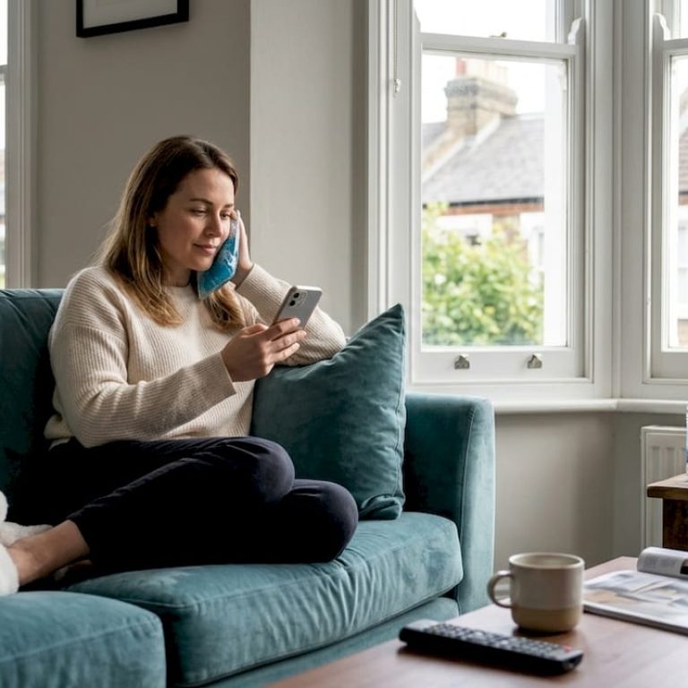 Woman using ice pack after injectable at home